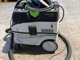 an image of a dust extracter sitting on the ground next to pallets
