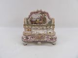 a miniature desk with a painting on it