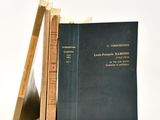 two books sitting on top of each other next to a ruler
