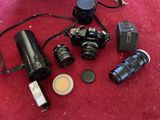 a lot of different cameras and lenses on the floor