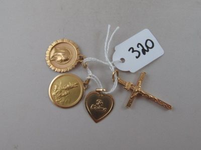 a cross, a medal, a medal, and a medal on a table