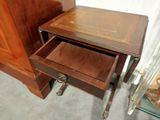a small wooden table with a drawer underneath it
