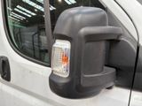 a side view mirror on the side of a white truck