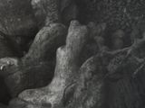 a black and white photo of an angel statue in a cave
