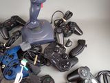 a pile of video game controllers and controllers on a table