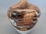 a glass vase with a brown and white design on it