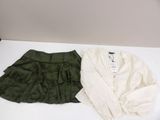 two pieces of clothing sitting on top of a table next to each other