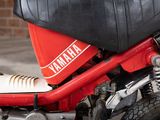 a close up of a red motorcycle with a black seat
