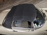 a car that is parked in a garage with its roof down