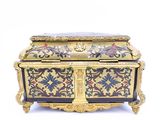 a gold and black box with flowers and birds on it