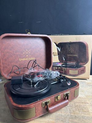 a suitcase with a record player in it on a table