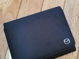 black laptop case with a white logo on it sitting on a wooden floor