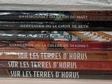 a lot of books that are stacked on top of each other