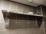 a shelf with plates and cups on it in a bathroom