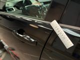 a sticker on the door handle of a car