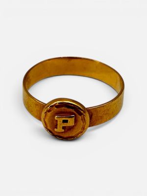 a close up of a gold ring with the letter f on it