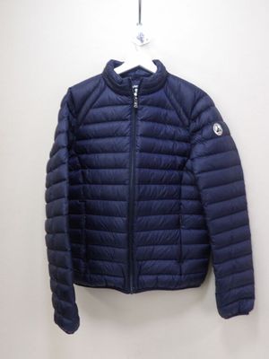 a close up of a blue jacket hanging on a wall