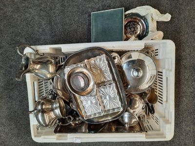 vue du dessus d'un conteneur rempli d'objets en argent posé sur un sol recouvert de moquette