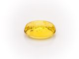 a yellow sapphire stone on a white background