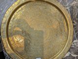 a gold plate on a marble table with a sticker on it