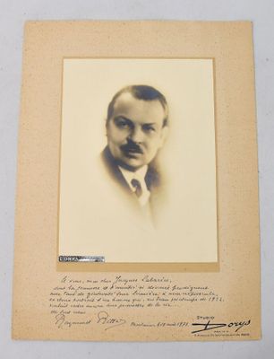 an old photo of a man in a suit and tie with a handwritten note