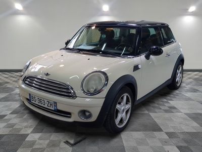 a picture of a white mini cooper parked in a garage