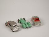 three toy cars sitting next to each other on a table
