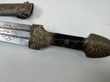 two knives that are sitting on a table