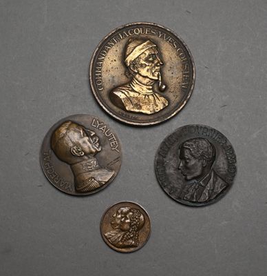 three coins are shown on a gray surface, one has a bust and the other has a bust