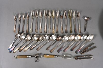 a lot of spoons and forks laid out on the table