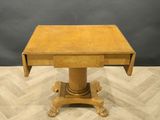 a small wooden table with a drawer on top of it