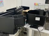 many computers and laptops sitting on a desk