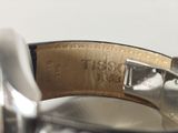 a close up of a watch with a leather band
