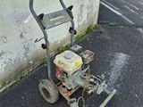 a small lawn mower sitting on the ground next to a building