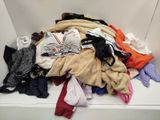 a pile of clothes sitting on a shelf in a room