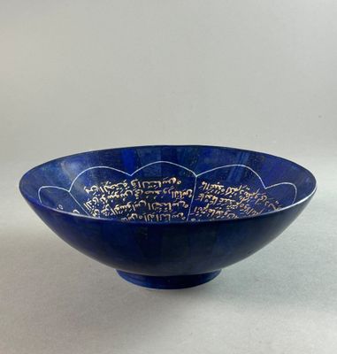 a close up of a blue bowl with writing on it