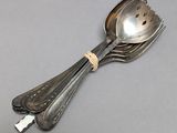 two spoons and a spoon with a handle on a table