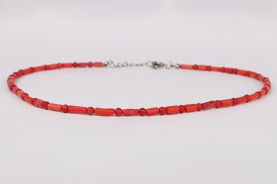 a red beaded necklace on a white background