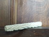 une corde blanche posée sur une table près d'une porte en bois