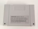 an old nintendo game console sitting on top of a white table