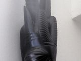 a black mask with horns on the wall next to a shelf