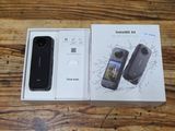 packaging of a black cell phone in a box on a wooden table
