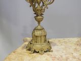 a gold colored candle holder on a marble table