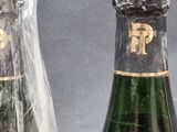 two bottles of champagne that are wrapped in plastic