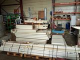 a large pile of wood in a warehouse with pallets