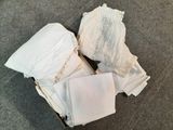 a box full of underwear on the floor next to a pair of shoes