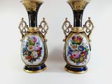 pair of vases decorated with flowers on a white background