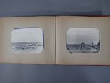 an old photo of a book opened to show a picture of a farm