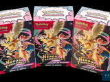 trois paquets de cartes Pokémon sont empilés les uns sur les autres