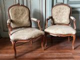 two chairs sitting next to each other on a wooden floor